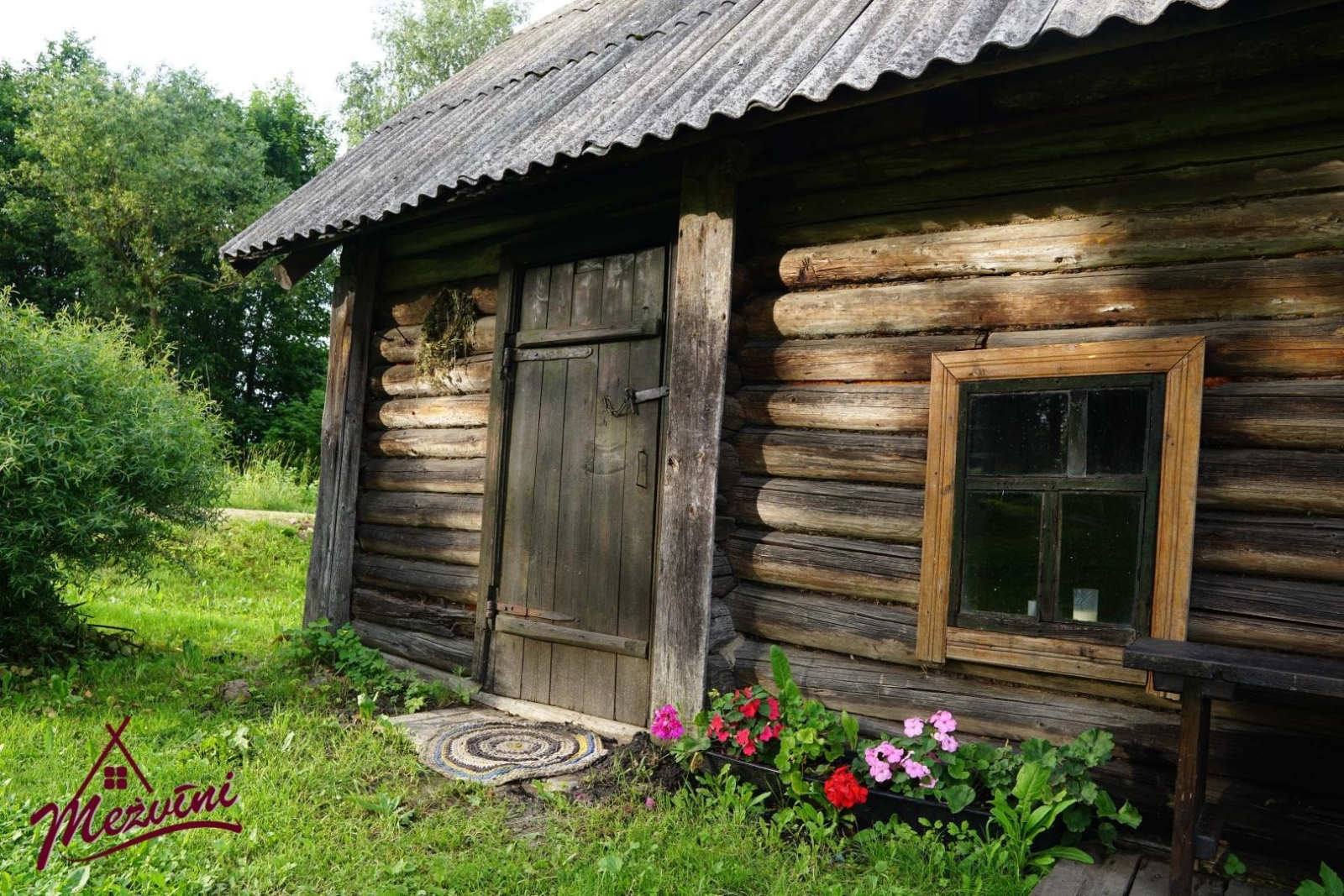 Koka saimniecības ēka ar ziediem
