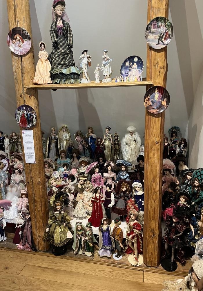 Porcelāna leļļu kolekcija vitrīnā